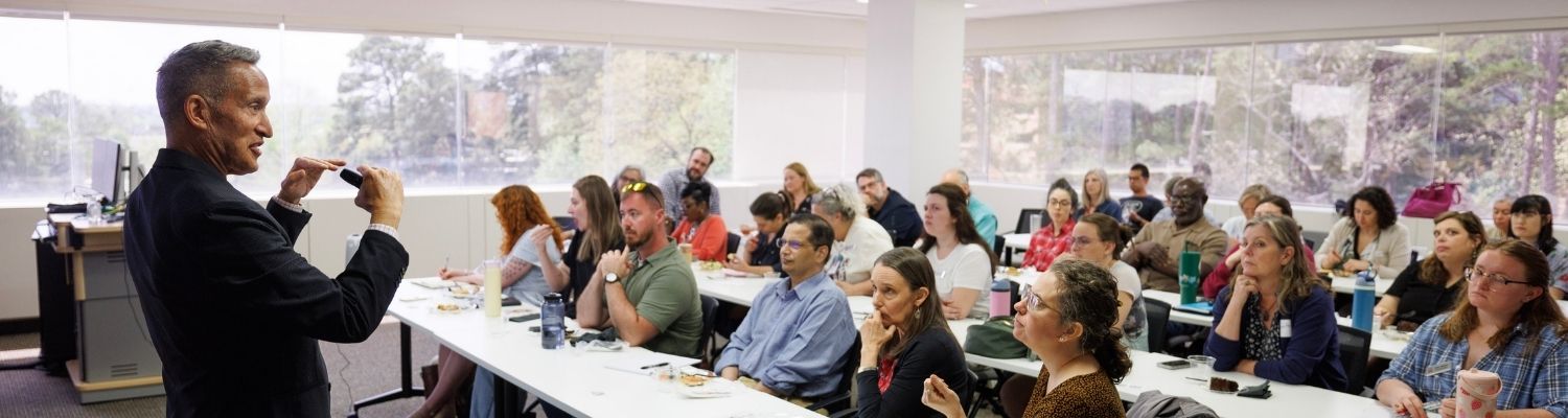 instructor teaching a full classroom